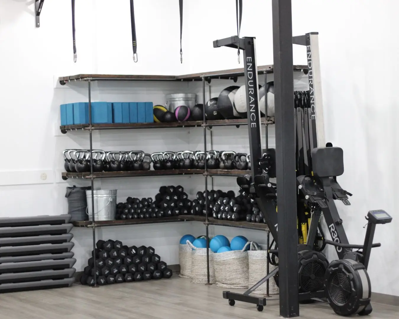 Various workout equipment, neatly organized in studio of Clemson Fitness Company.
